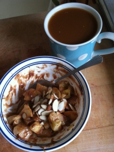 Warm cooked apples, cinnamon, and almond butter with a side of coffee. A delicious Paleo breakfast substitute for oatmeal.
